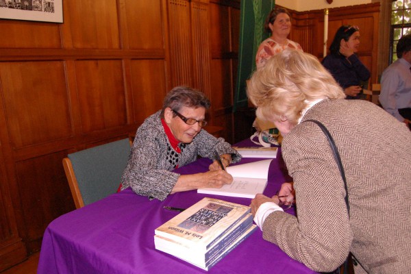 Rev. Wilson signs a copy of her book I Want to Be in That Number at a 2014 launch event at Emmanuel College.