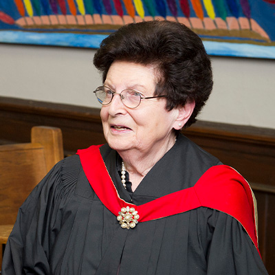 Eva Kushner wearing a commencement gown.