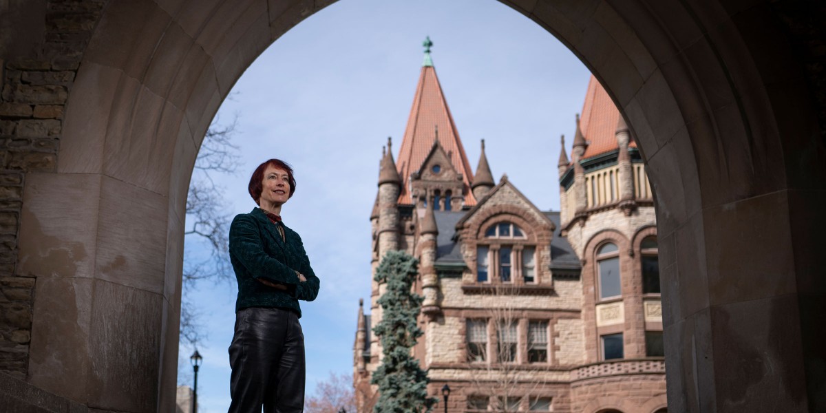 Angela Esterhammer standing proudly in front of the Old Vic building.